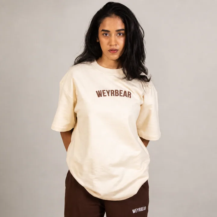 Woman wearing Weyrbear's solid beige oversized cotton T-shirt